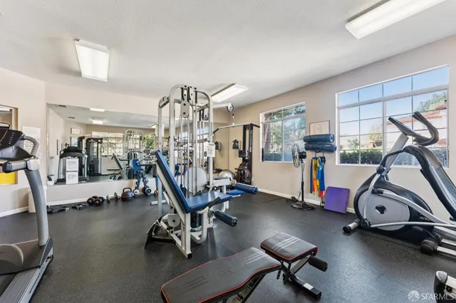 a room with gym equipment and windows