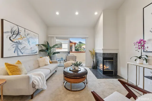 a living room with furniture and a fireplace