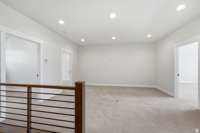496 North Farmhouse Way, Unit 11 Midway, UT 84049 - Photo 31 of 50 Open landing area featuring light-toned carpet, recessed ceiling lighting, and a modern wood-finish railing with horizontal balusters