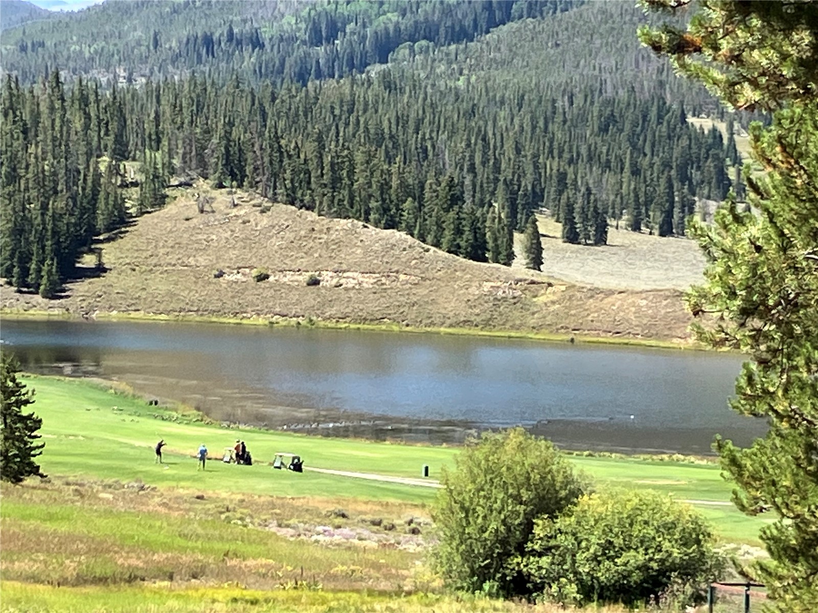 View of golf course and lake from deck
