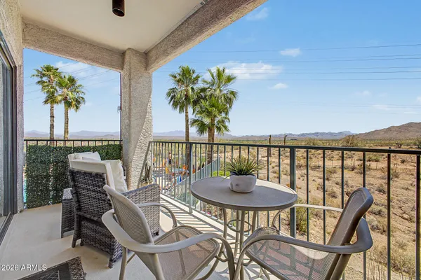 a view of a balcony with table and chairs