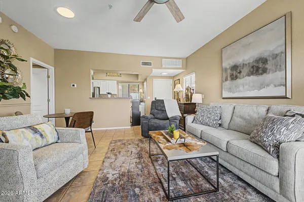 a living room with furniture a rug and a painting on the wall