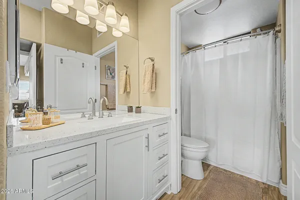 a bathroom with a double vanity sink mirror and toilet