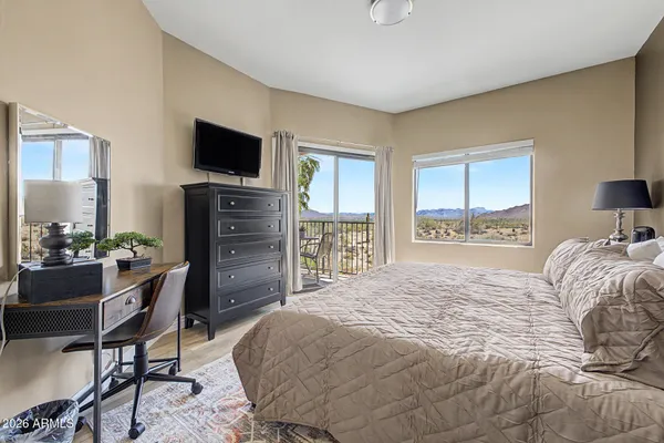 a bedroom with a bed and a flat screen tv