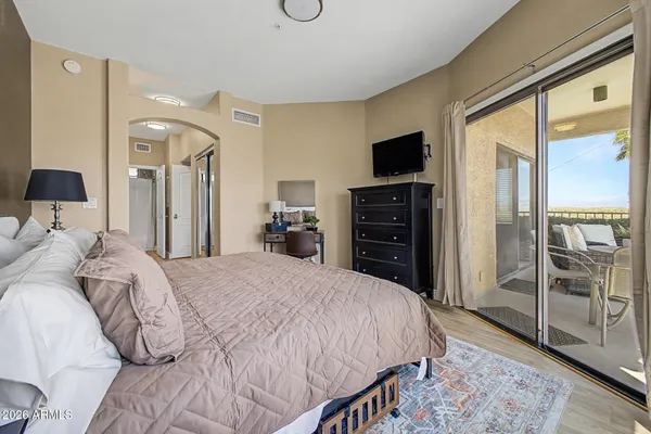 a bedroom with a bed and a flat screen tv