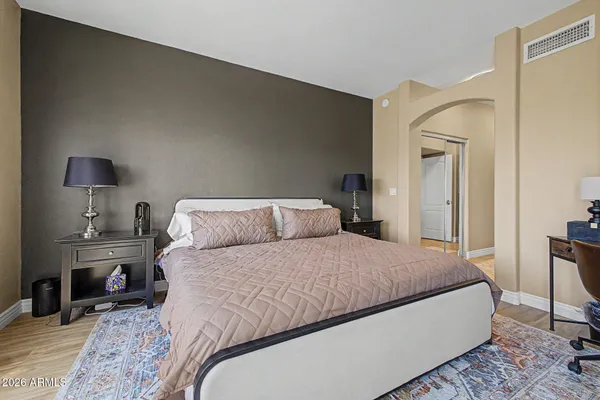 a bedroom with a bed a table and chair