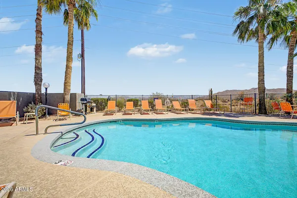 a view of swimming pool with a table and chairs