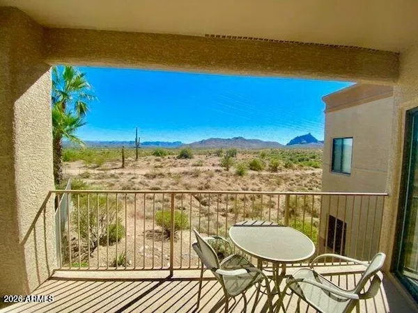 a view of a balcony with chair and table