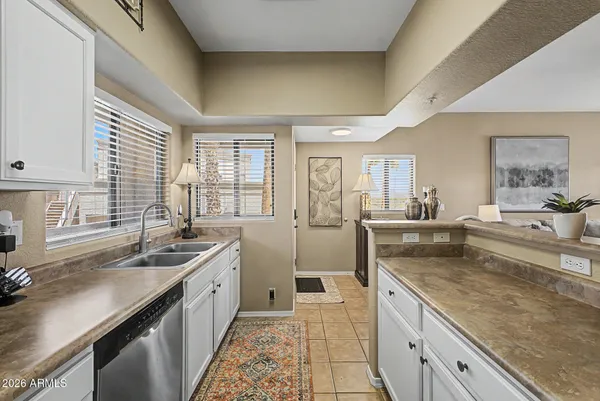 a large kitchen with kitchen island granite countertop a sink and a large window