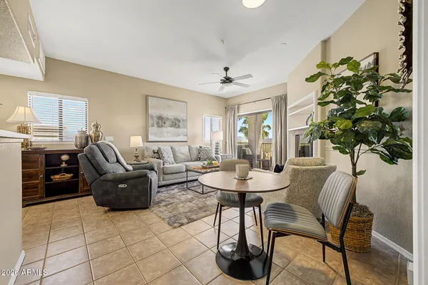 a living room with furniture a chandelier and a table