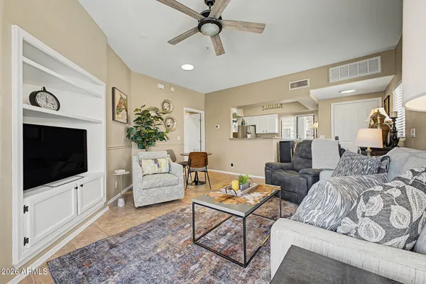 a living room with furniture a flat screen tv and a fireplace