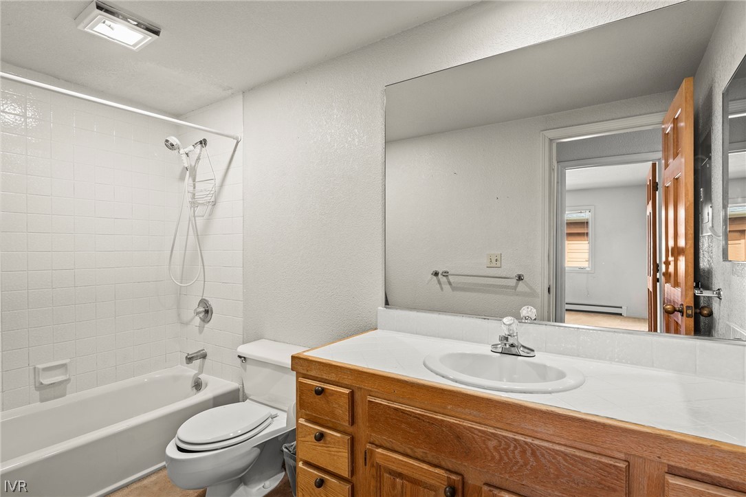 947 Incline Way, Unit 189 Incline Village, NV 89451 - Photo 13 of 21 a bathroom with a granite countertop sink toilet a mirror and shower