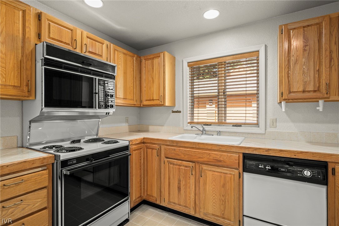 947 Incline Way, Unit 189 Incline Village, NV 89451 - Photo 9 of 21 a kitchen with granite countertop cabinets stainless steel appliances and a window
