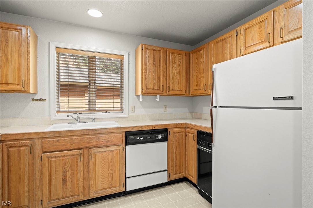 947 Incline Way, Unit 189 Incline Village, NV 89451 - Photo 10 of 21 a kitchen with white cabinets and a refrigerator