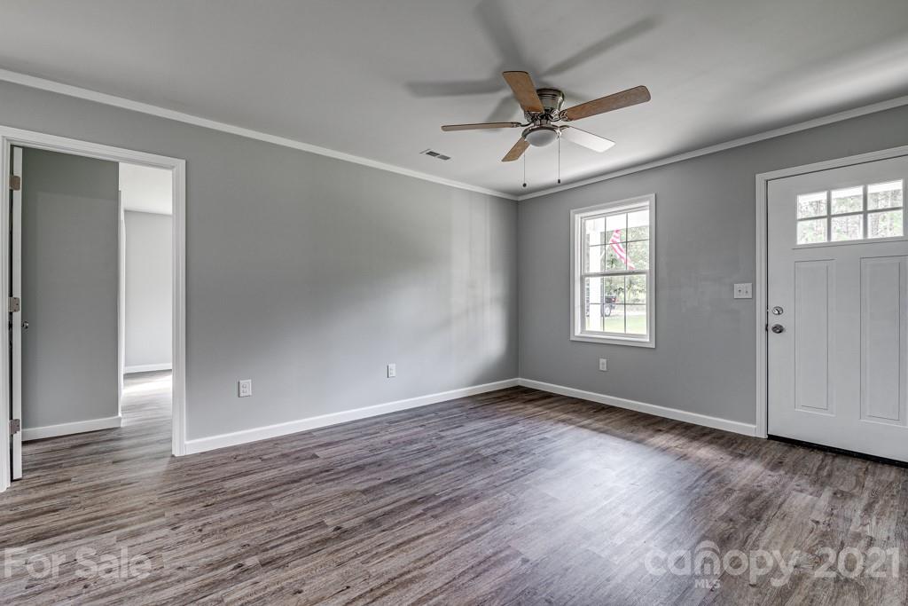 1322 Miller-Flat Road, Unit 1 Jefferson, SC 29718 - Photo 16 of 32 a view of an empty room with wooden floor and a window