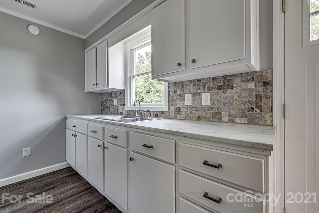1322 Miller-Flat Road, Unit 1 Jefferson, SC 29718 - Photo 23 of 32 a kitchen with granite countertop white cabinets and a sink