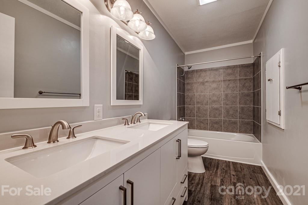 1322 Miller-Flat Road, Unit 1 Jefferson, SC 29718 - Photo 27 of 32 a bathroom with a sink a toilet a mirror and shower
