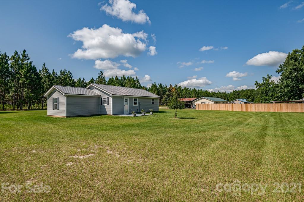 1322 Miller-Flat Road, Unit 1 Jefferson, SC 29718 - Photo 29 of 32 a view of a house with a big yard and a large tree
