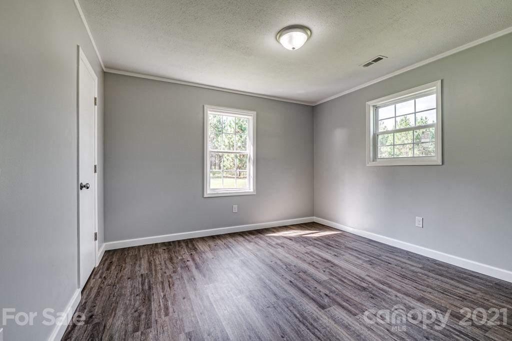 1322 Miller-Flat Road, Unit 1 Jefferson, SC 29718 - Photo 4 of 32 an empty room with wooden floor and windows