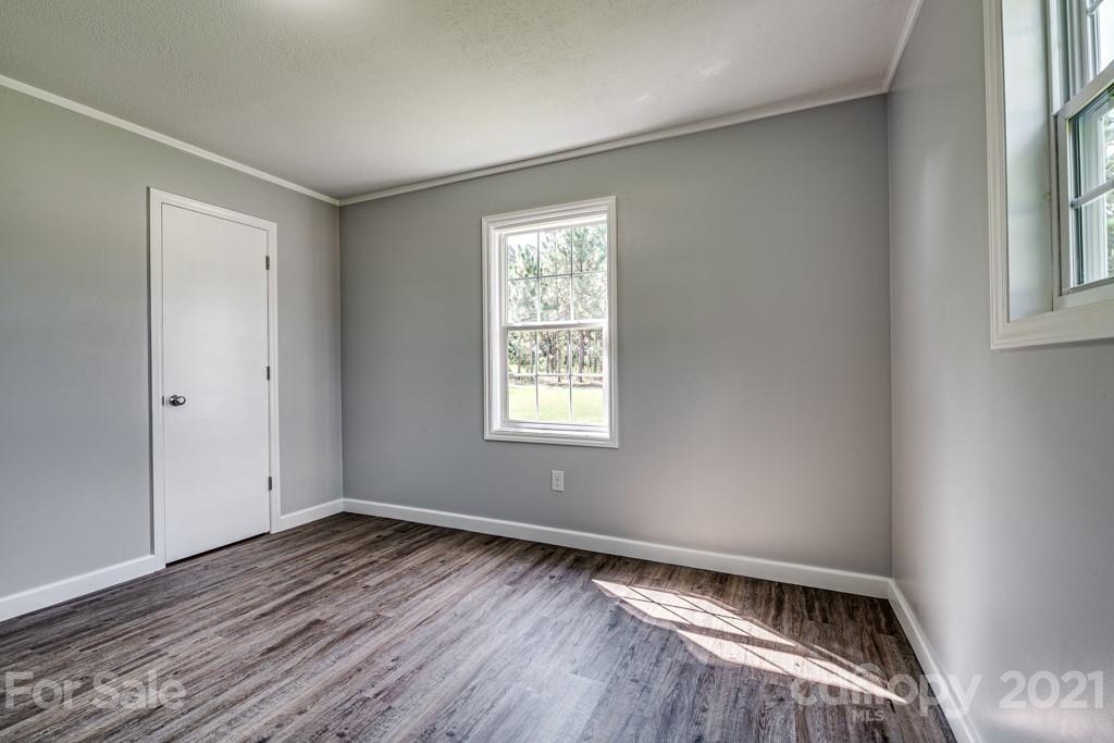 1322 Miller-Flat Road, Unit 1 Jefferson, SC 29718 - Photo 5 of 32 a view of an empty room with wooden floor and a window