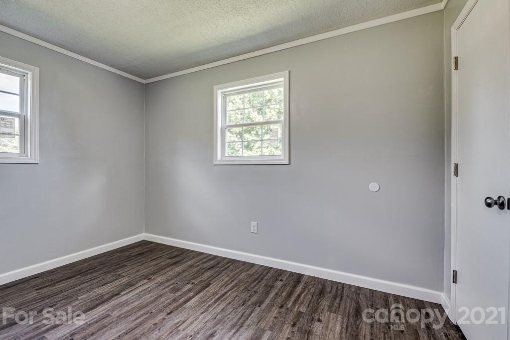1322 Miller-Flat Road, Unit 1 Jefferson, SC 29718 - Photo 7 of 32 a view of an empty room with wooden floor and a window
