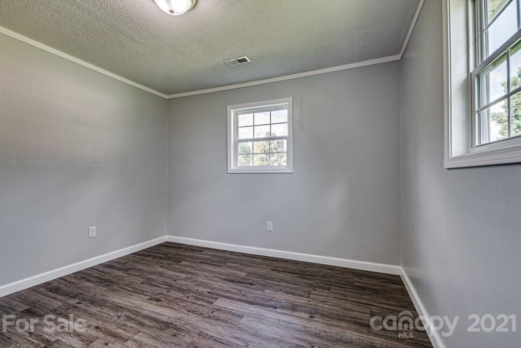 1322 Miller-Flat Road, Unit 1 Jefferson, SC 29718 - Photo 8 of 32 an empty room with wooden floor and windows
