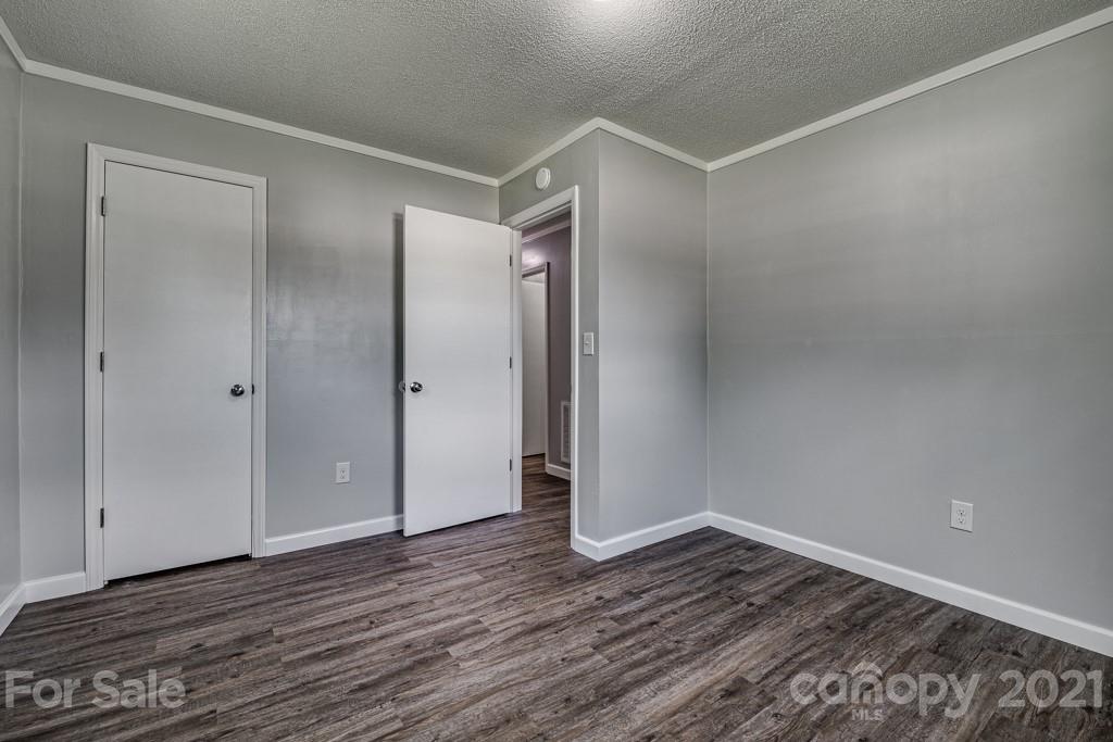 1322 Miller-Flat Road, Unit 1 Jefferson, SC 29718 - Photo 9 of 32 a view of an empty room with wooden floor and bathroom