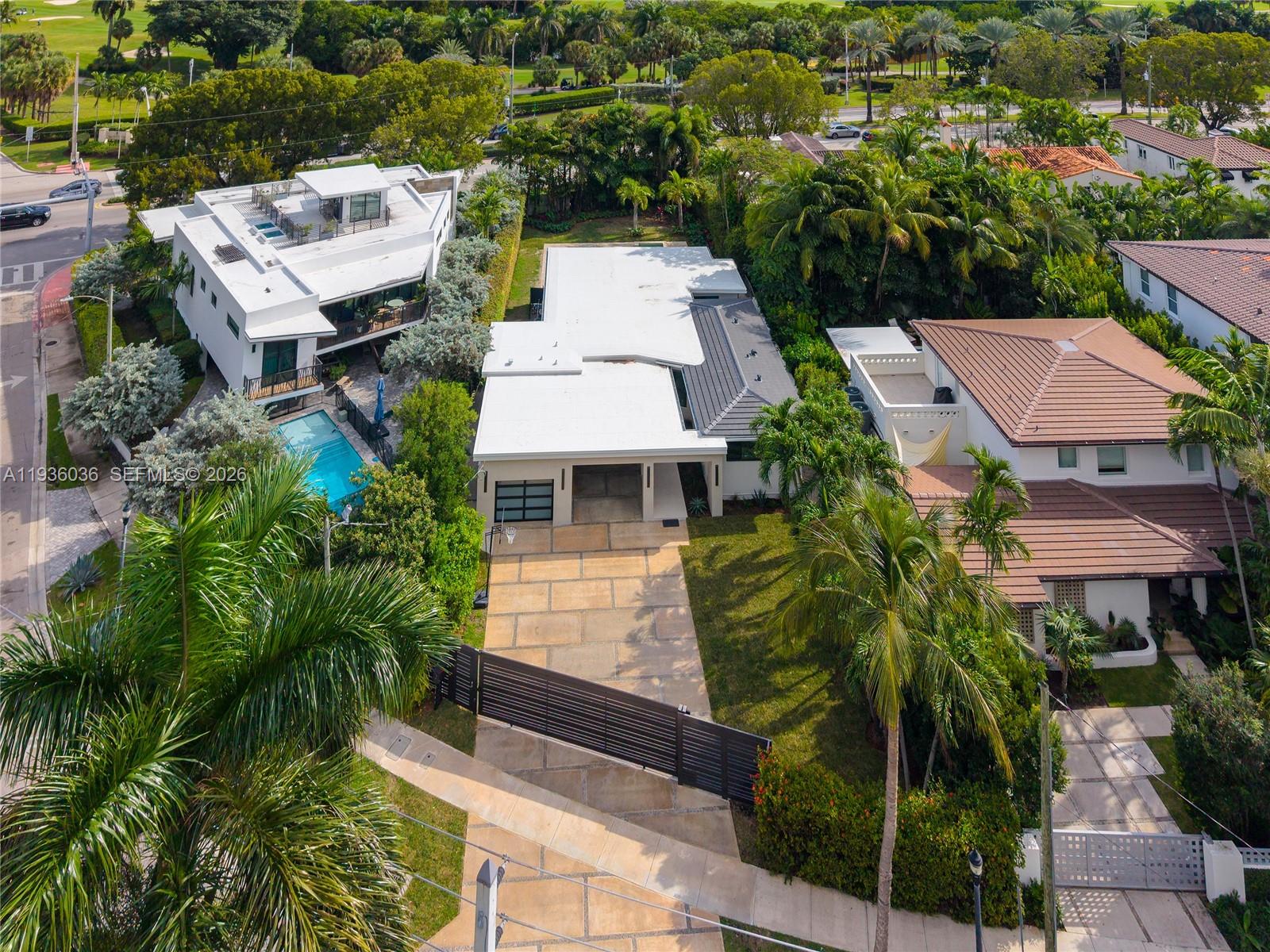 an aerial view of a house with a yard and lake view