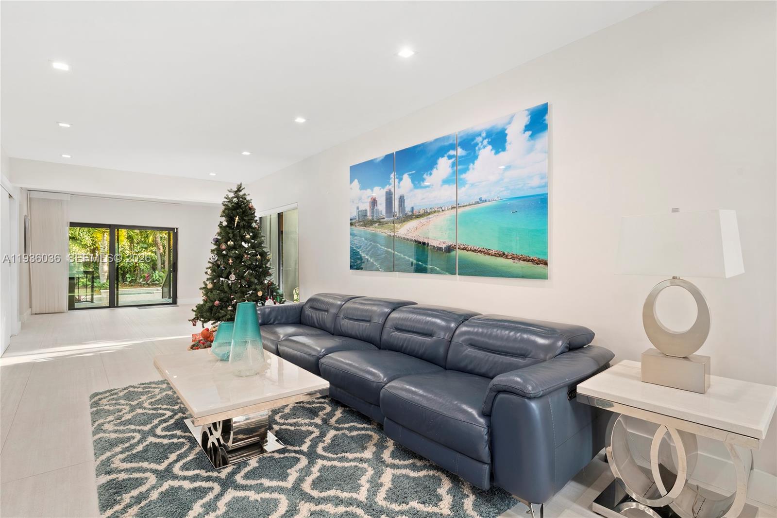 3141 North Bay Road Miami Beach, FL 33140 - Photo 13 of 50 a living room with furniture wooden floor and a large window