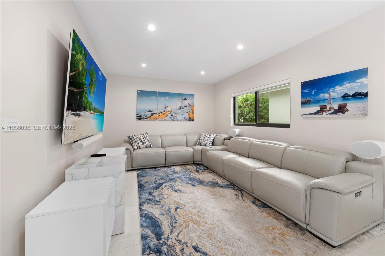 3141 North Bay Road Miami Beach, FL 33140 - Photo 16 of 50 a living room with furniture and a flat screen tv