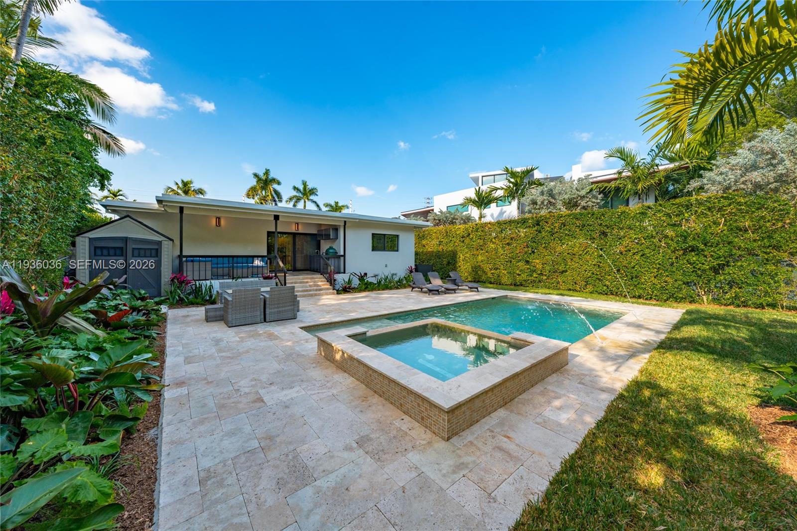 3141 North Bay Road Miami Beach, FL 33140 - Photo 20 of 50 a view of a house with swimming pool and sitting area