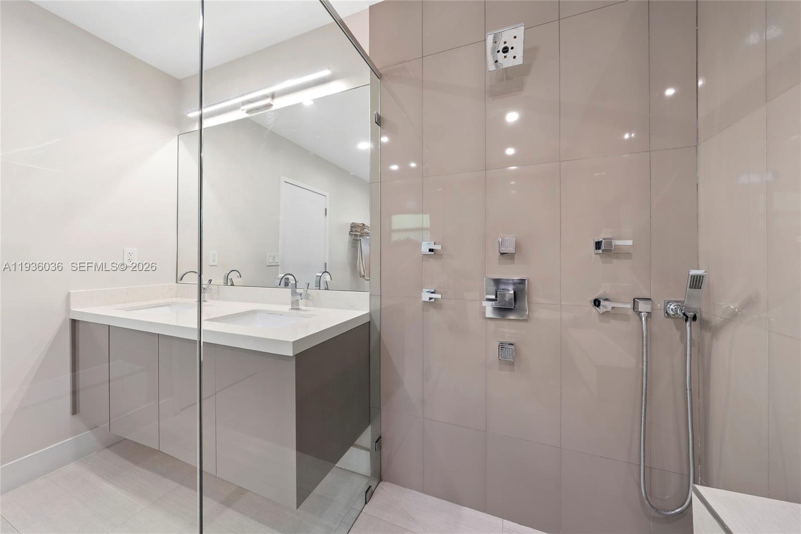 3141 North Bay Road Miami Beach, FL 33140 - Photo 28 of 50 a bathroom with a sink and mirror