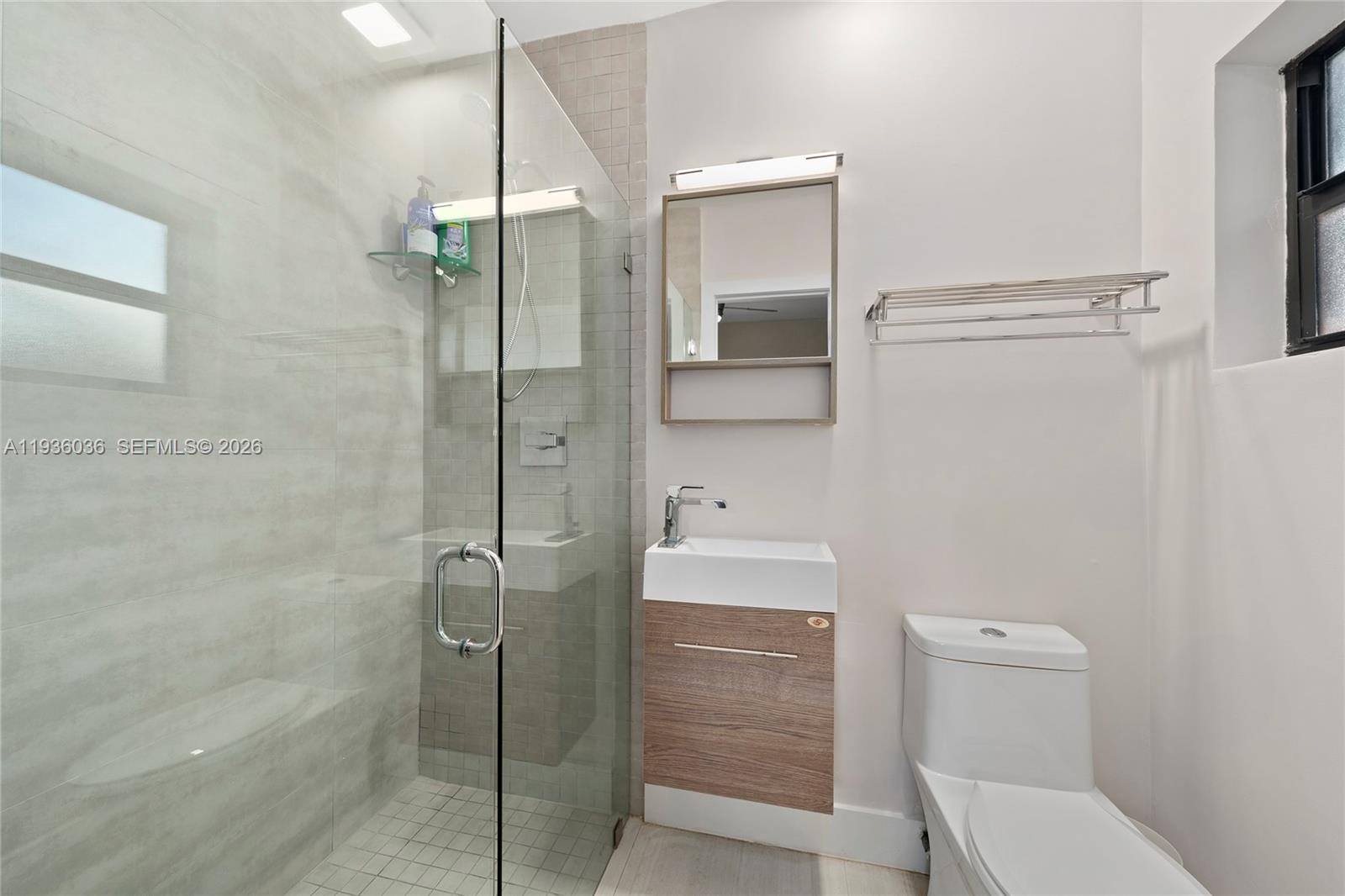 3141 North Bay Road Miami Beach, FL 33140 - Photo 35 of 50 a bathroom with a shower a toilet and sink