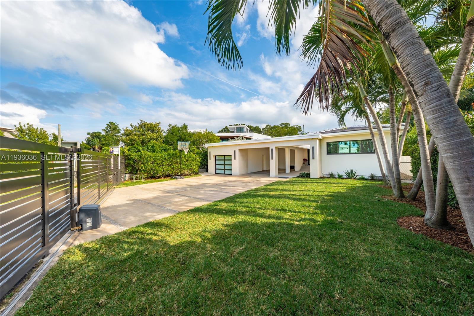3141 North Bay Road Miami Beach, FL 33140 - Photo 36 of 50 a view of a yard with a house
