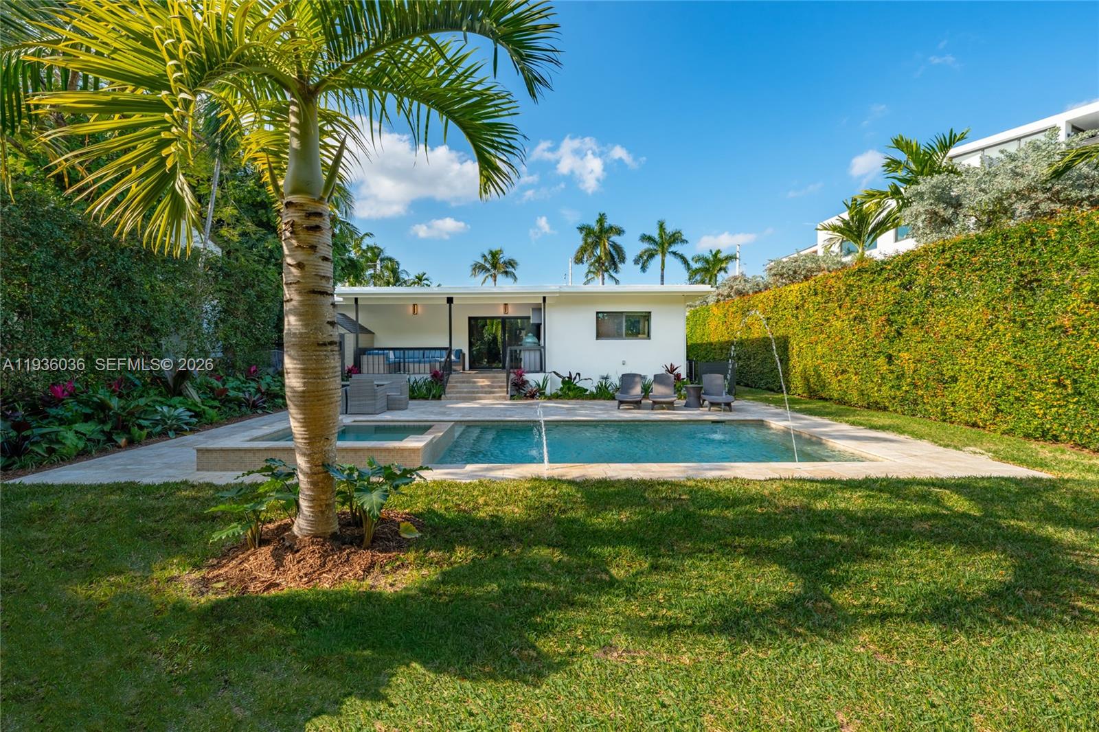 3141 North Bay Road Miami Beach, FL 33140 - Photo 42 of 50 a swimming pool with outdoor seating and yard