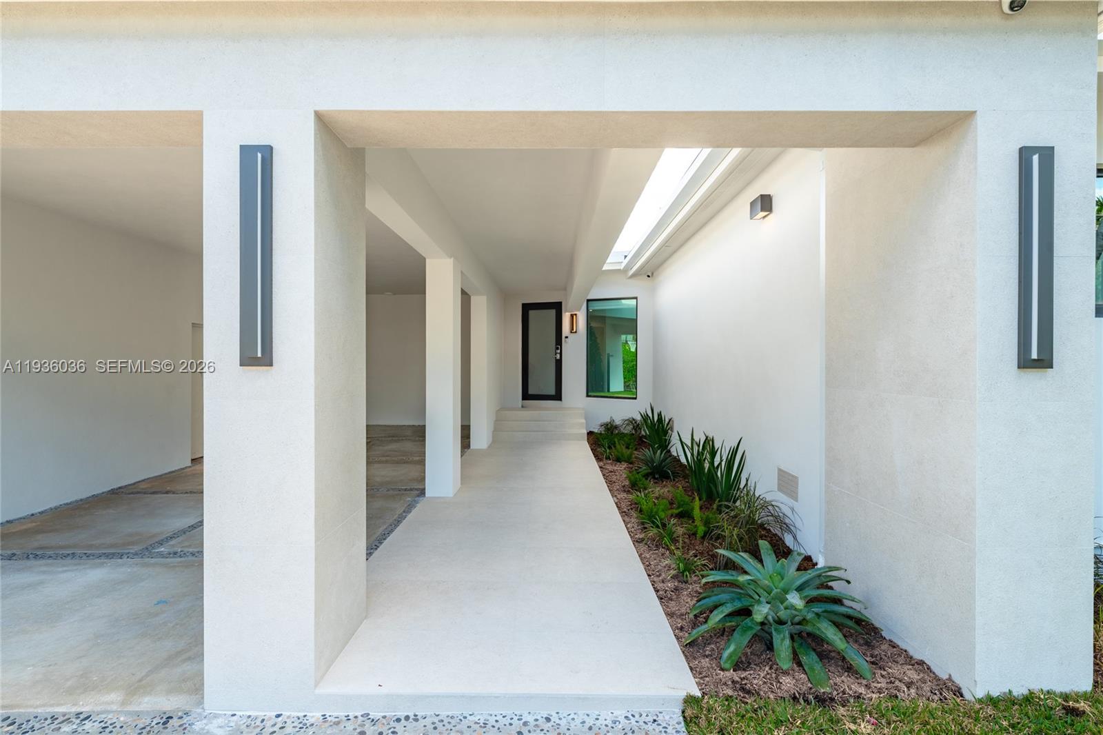 3141 North Bay Road Miami Beach, FL 33140 - Photo 5 of 50 a view of a hallway with potted plants