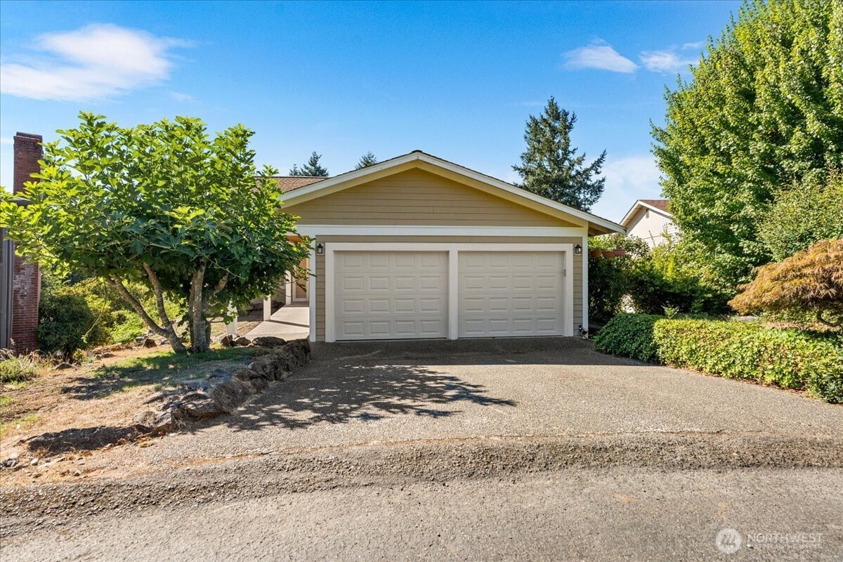 8707 45th Street West Tacoma, WA 98466 - Photo 1 of 39 a front view of a house with a yard and garage