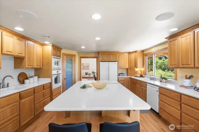a kitchen with stainless steel appliances a sink and a refrigerator