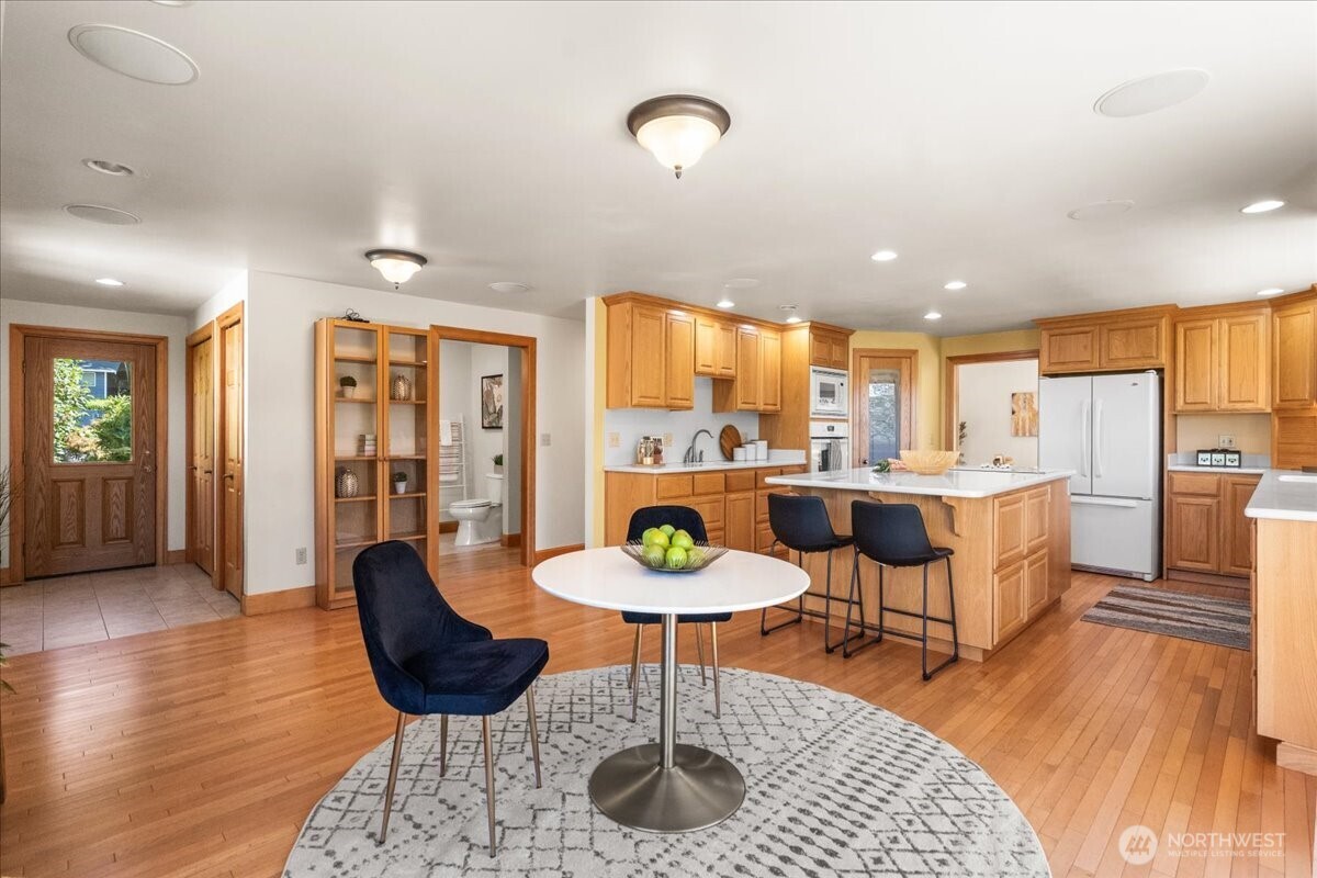 8707 45th Street West Tacoma, WA 98466 - Photo 19 of 39 a kitchen with a dining table chairs and view of living room