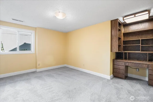 an empty room with closet and a bathroom