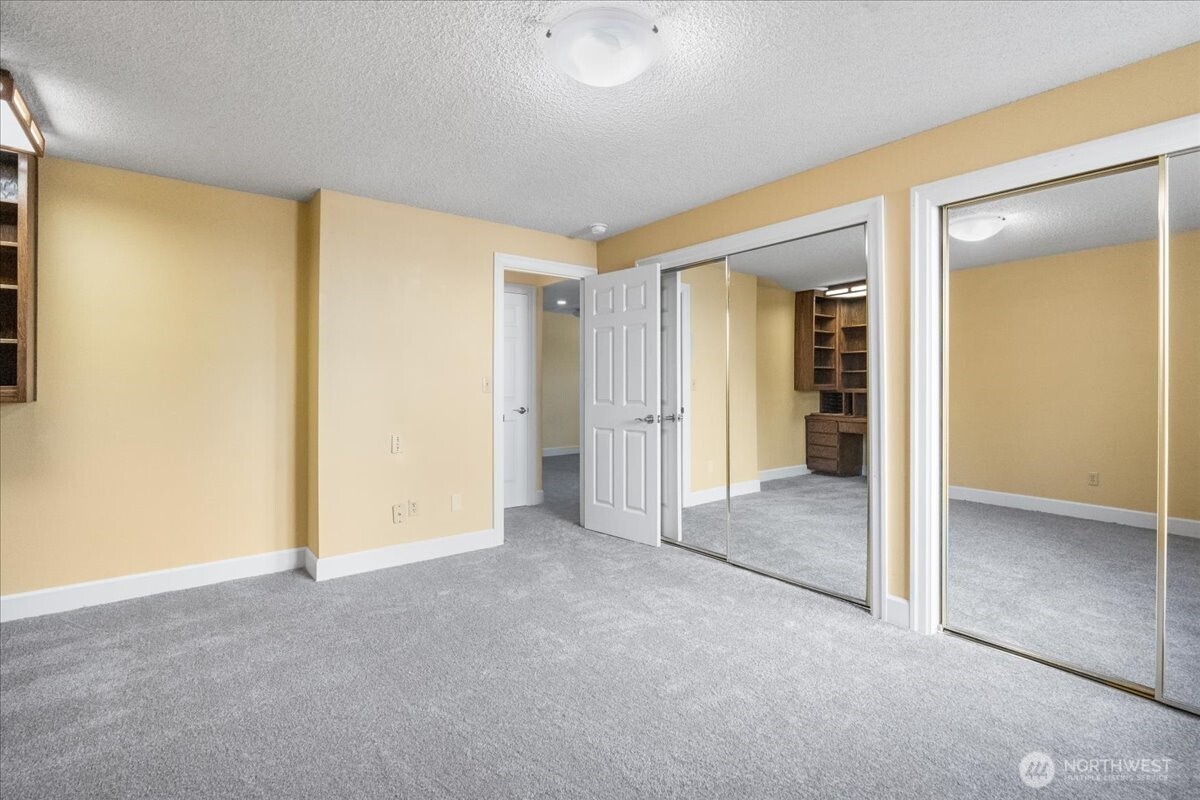 8707 45th Street West Tacoma, WA 98466 - Photo 31 of 39 an empty room with closet and a bathroom