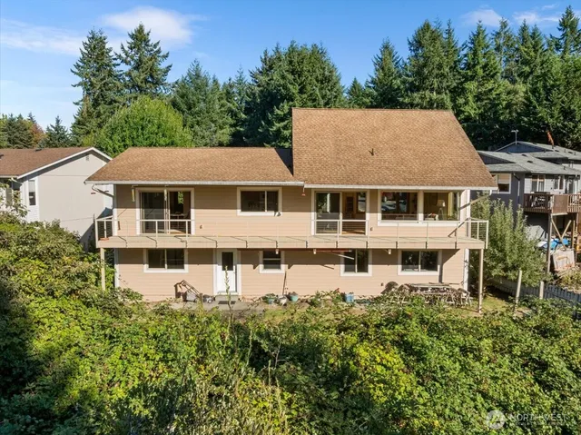 an aerial view of residential house with outdoor space and parking