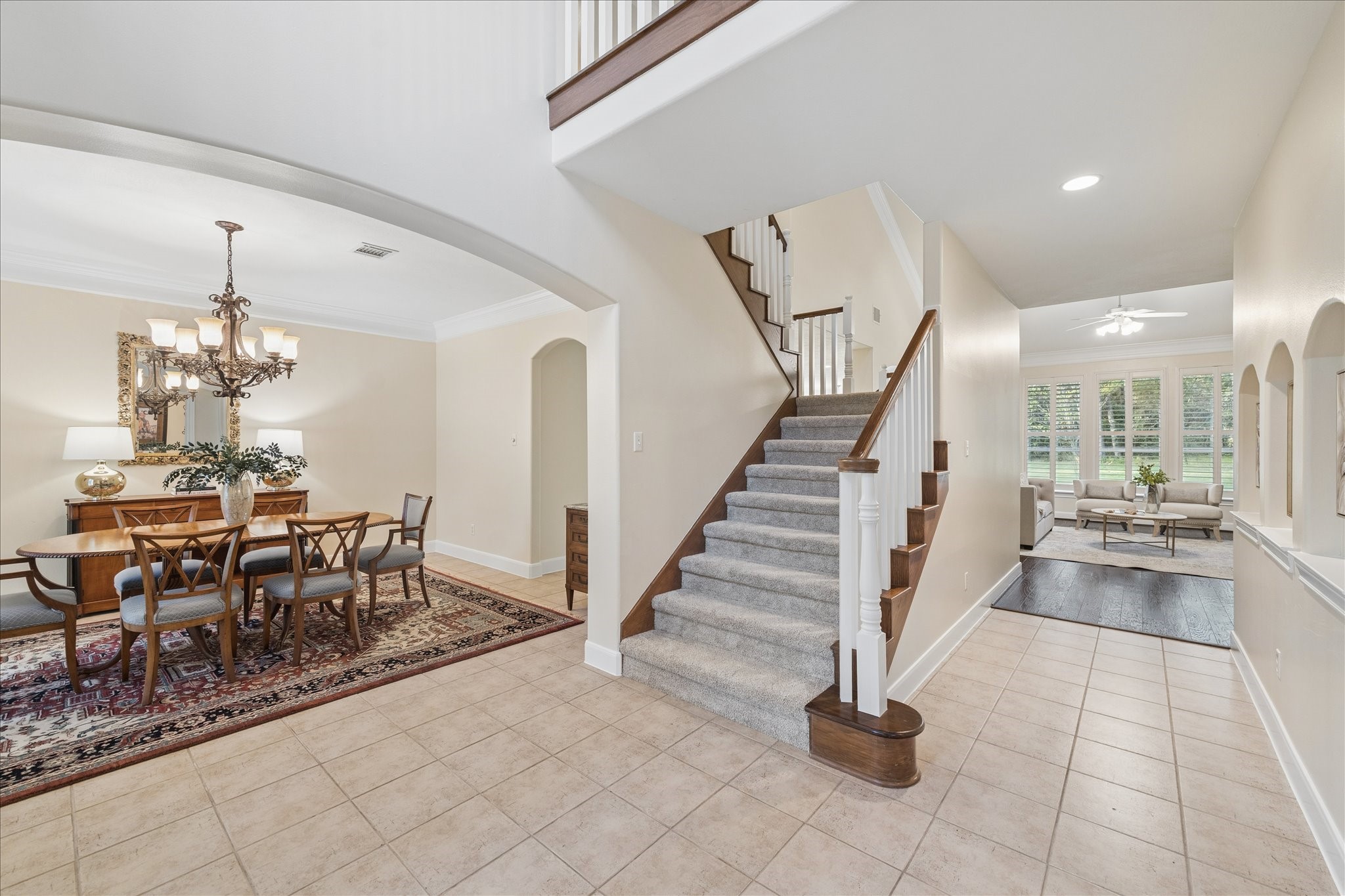 14530 Millhouse Road Pinehurst, TX 77362 - Photo 6 of 46 Welcoming entry with staircase centerpiece, flanked by a formal dining room to the left and a private office to the right, creating a functional and inviting layout.