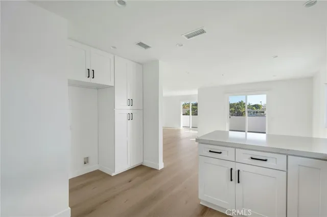 a view of kitchen with cabinets and window
