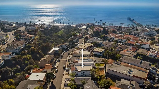 an aerial view of a city with ocean view