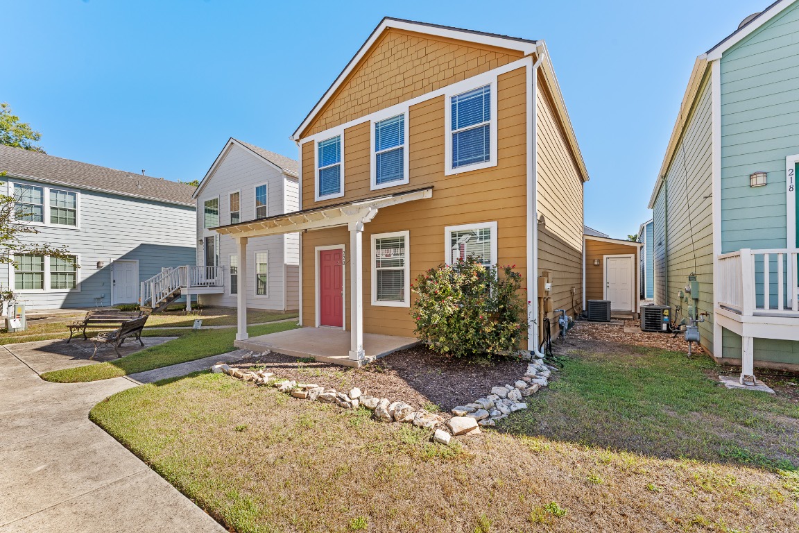 View of front of property featuring a front lawn and a patio
