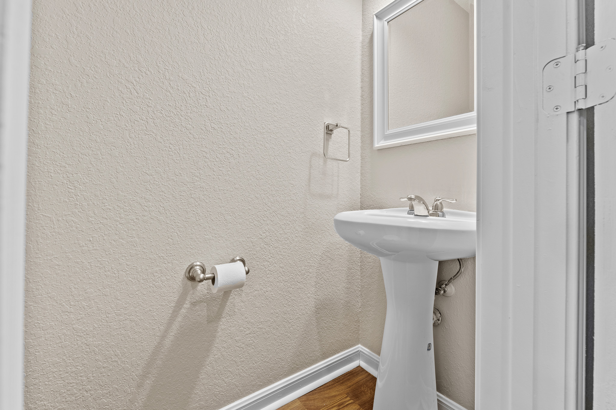 220 Trestle Tree San Marcos, TX 78666 - Photo 12 of 28 Bathroom featuring a textured wall and dark wood finished floors