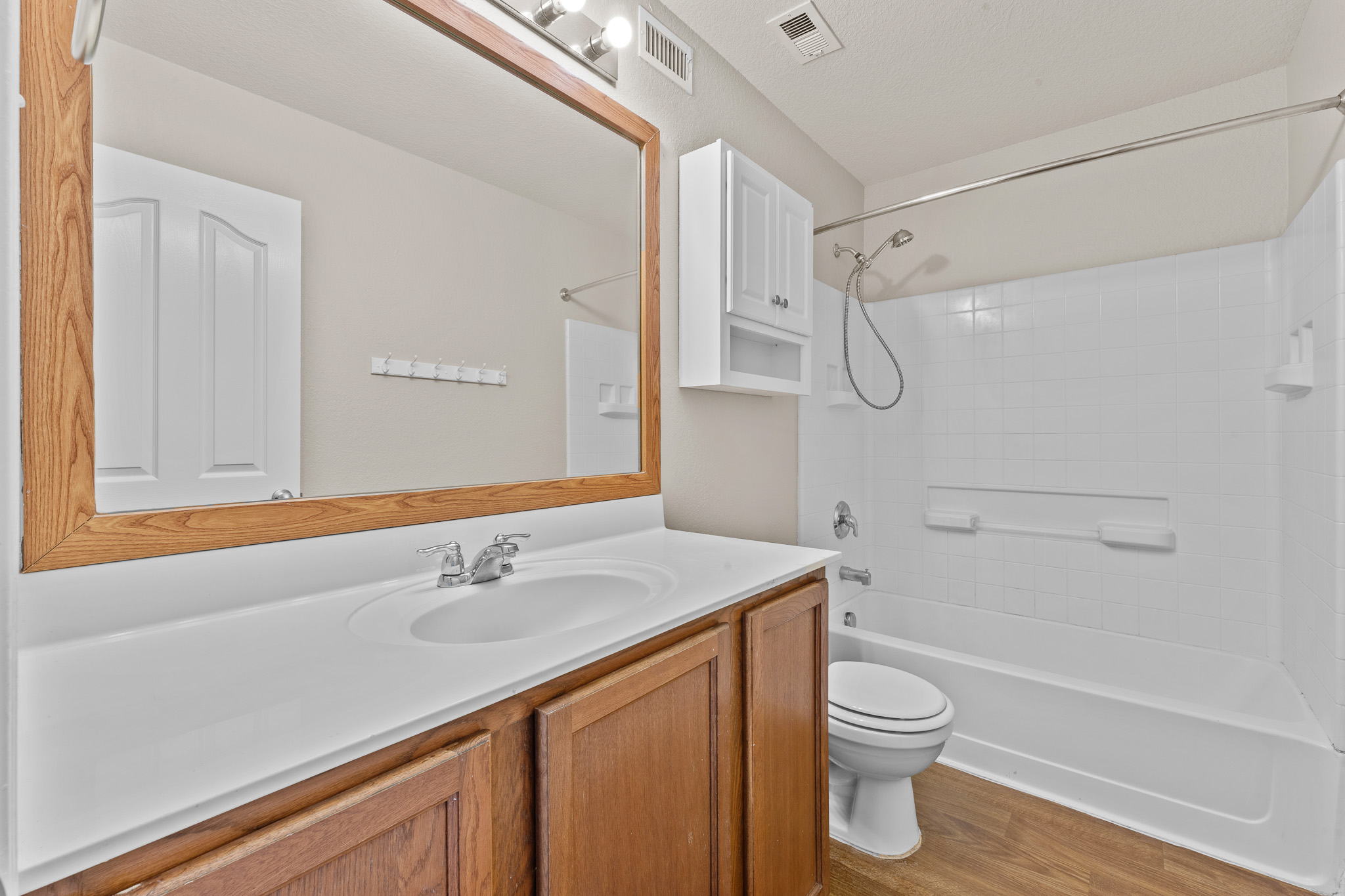 220 Trestle Tree San Marcos, TX 78666 - Photo 18 of 28 Full bath with shower / tub combination, vanity, and light wood finished floors