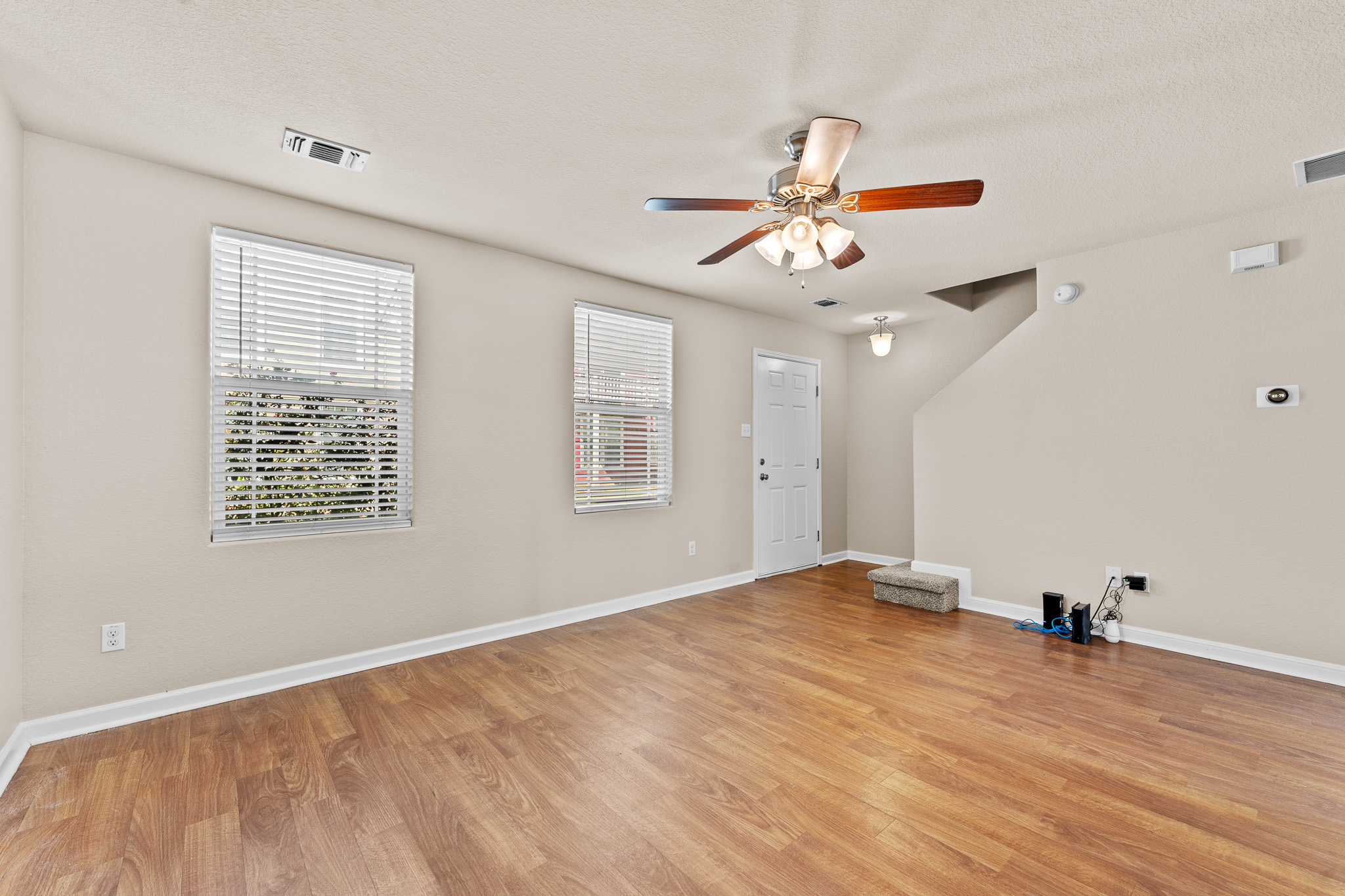 220 Trestle Tree San Marcos, TX 78666 - Photo 6 of 28 Empty room with light wood-style floors, a ceiling fan, and a textured ceiling