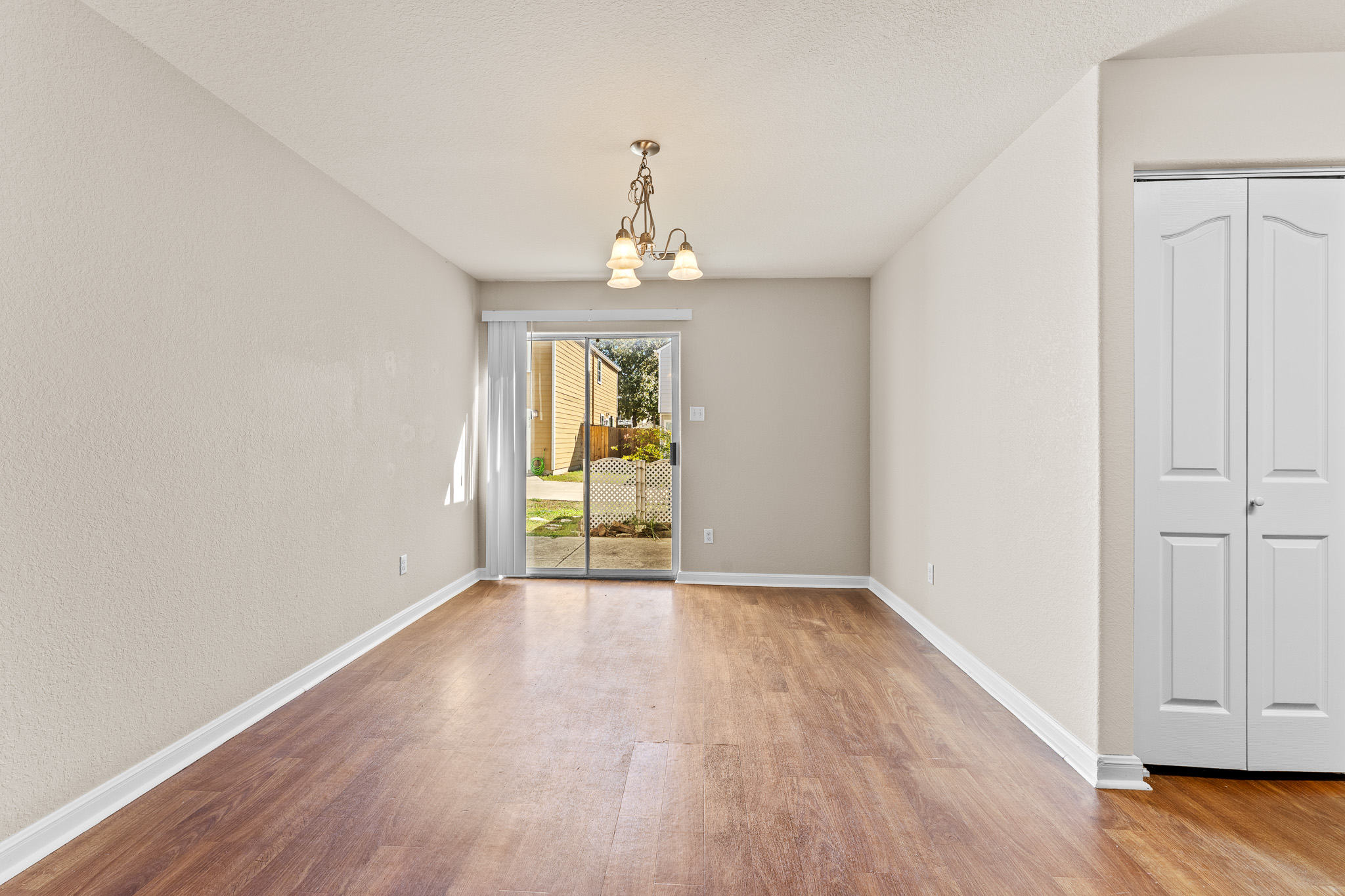 220 Trestle Tree San Marcos, TX 78666 - Photo 8 of 28 Unfurnished dining area featuring light wood-style floors and a chandelier